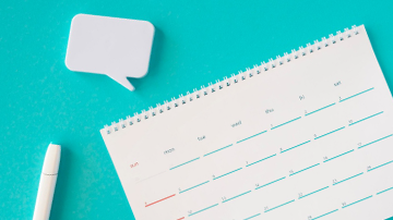 Photograph of a calendar, pen, and memo pad