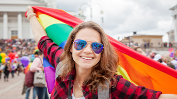 woman waving a rainbow flag