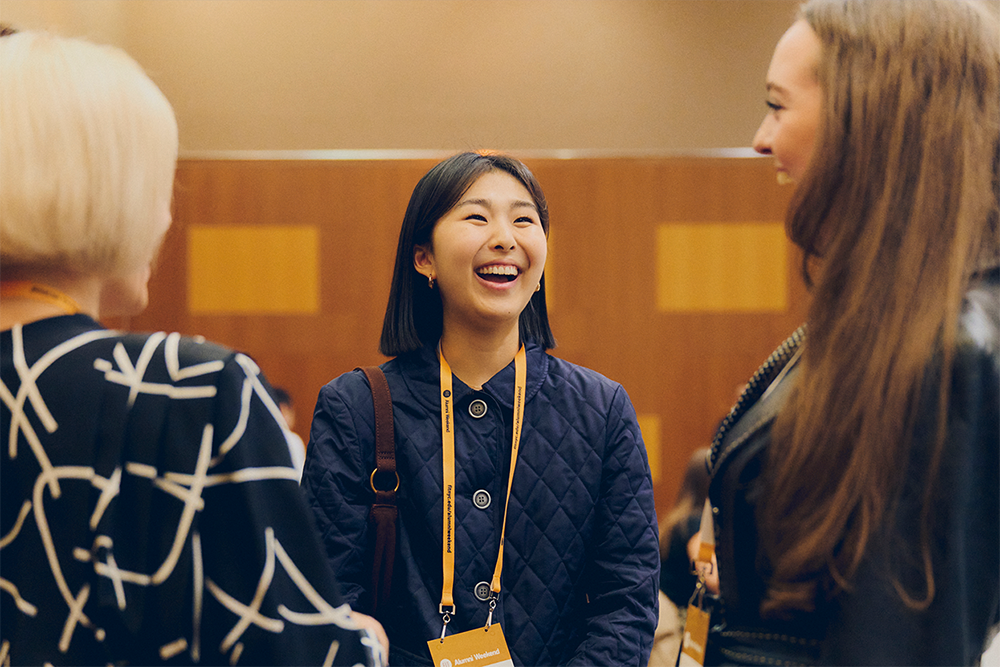 three alumni laugh as they chat at Alumni Weekend.