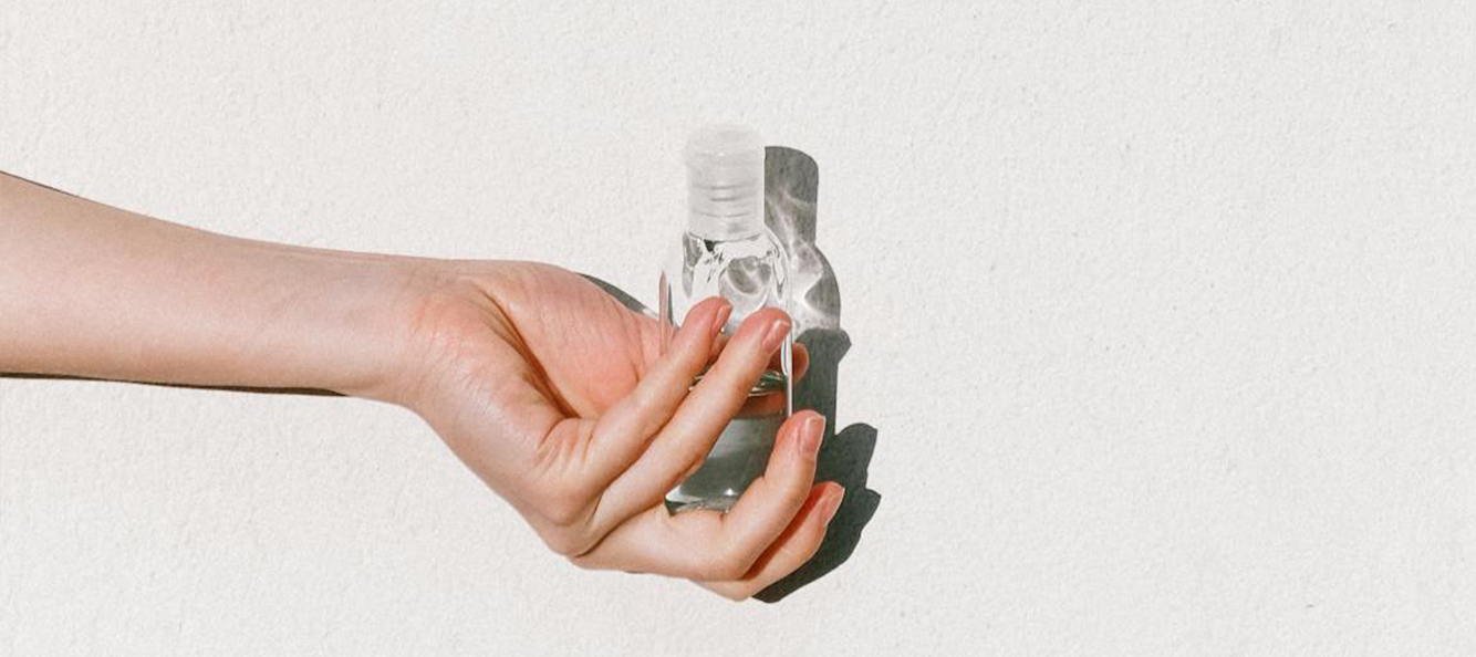Photograph of hand holding hand sanitizer