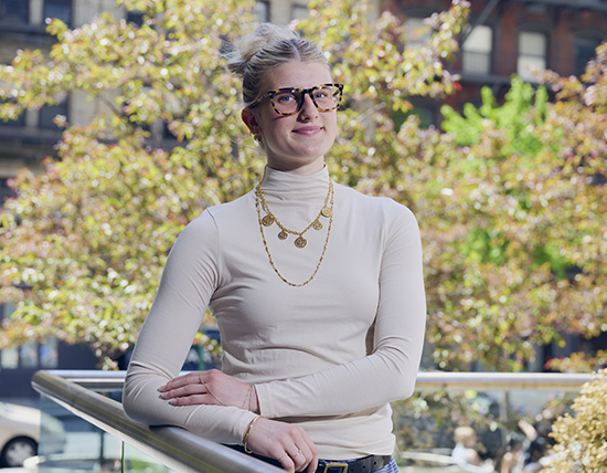 Student standing outside with folded arms