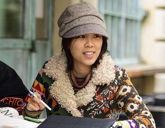 Student sitting and writing outside