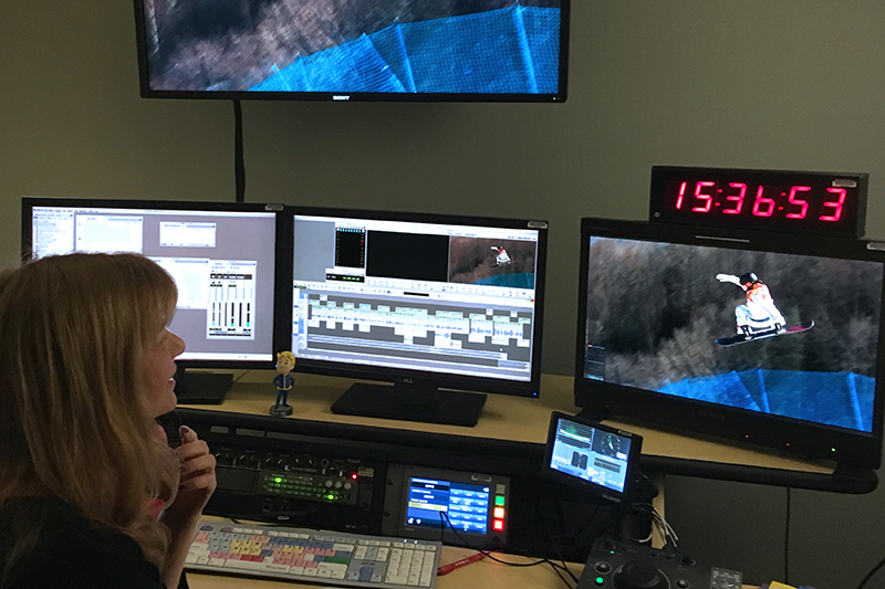 person at computer with monitors in background