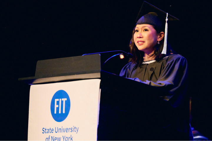speaker at lectern at master's graduation ceremony