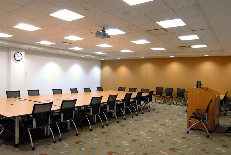conference table in the center of the room surrounded by chairs