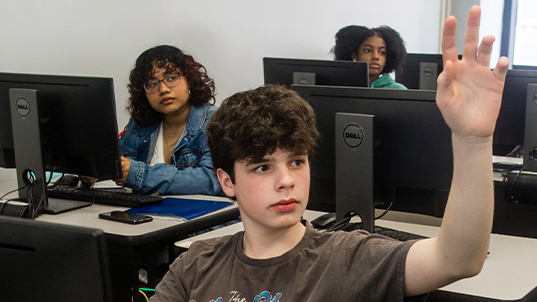 FITprecollege student raising his hand in classroom