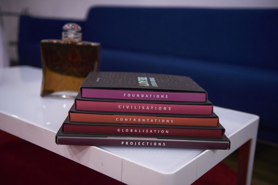 beauty center facilities, a closeup of books, a bottle of perfume, and a couch