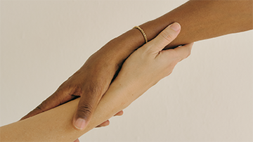 outreached hands helding each other