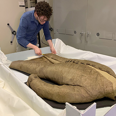 Philip DePaola working with George Washington's original inaugural suit.