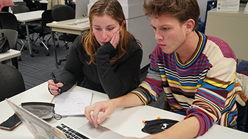 FIT student and tutor working together in front of computer