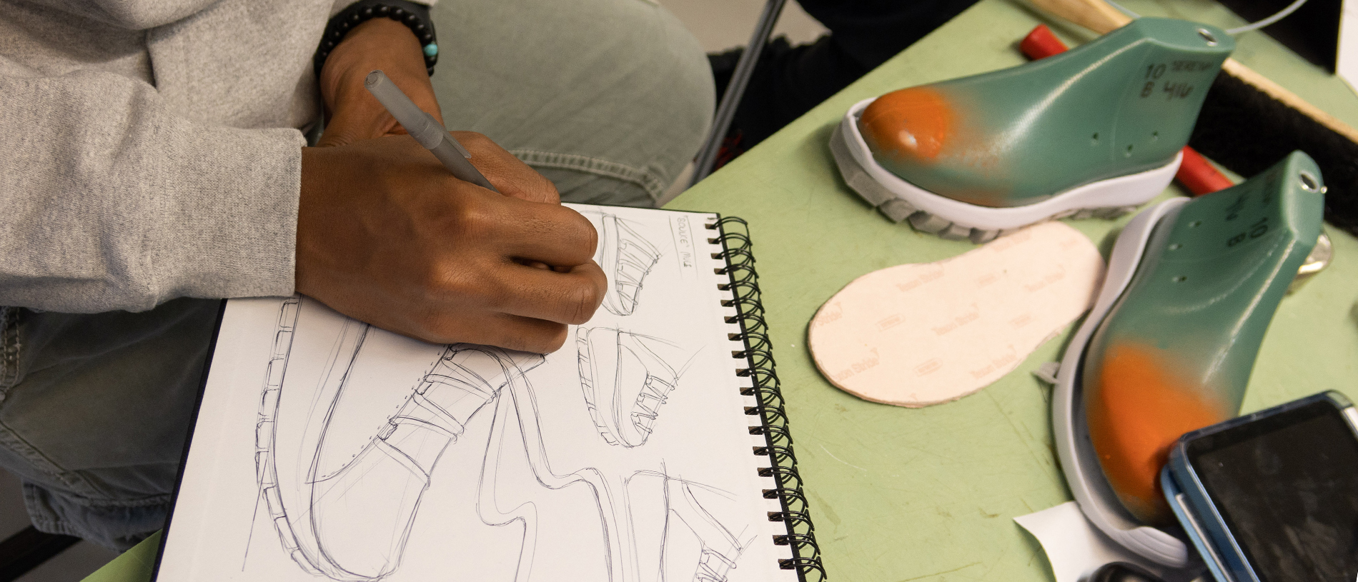 student drawing in Footwear and Accessories Design program at FIT