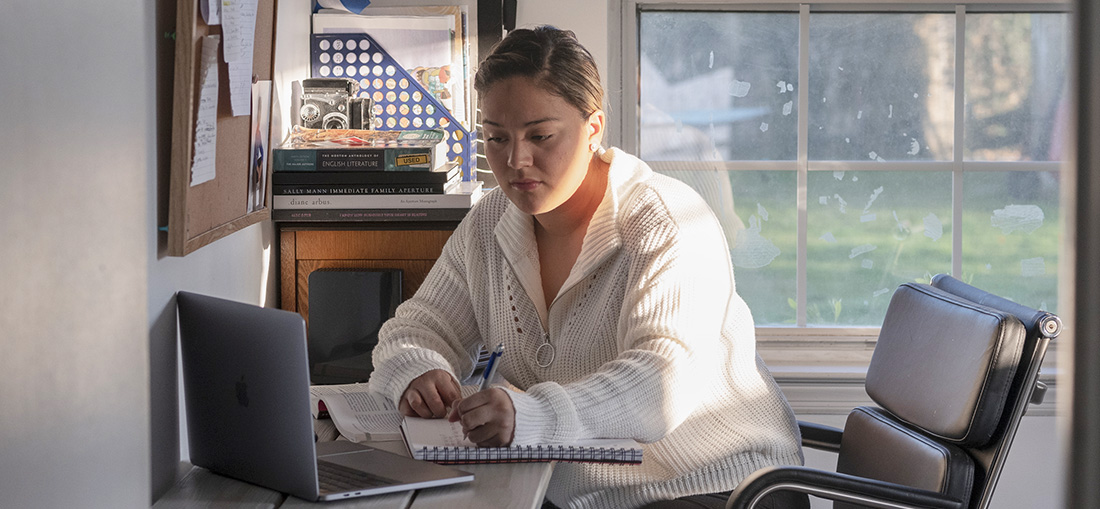 a woman writing in a notebook