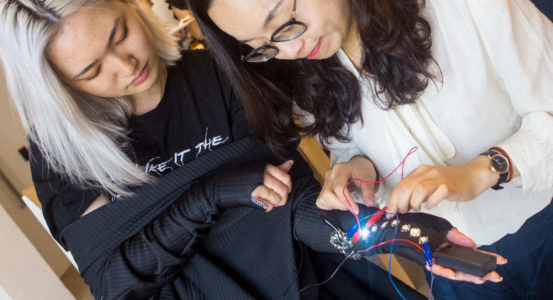 two FIT students working on electronic science project