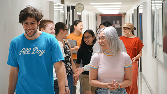 group of people walking through hallways on FIT campus