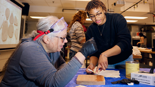 FIT faculty and student working on sustainability project together