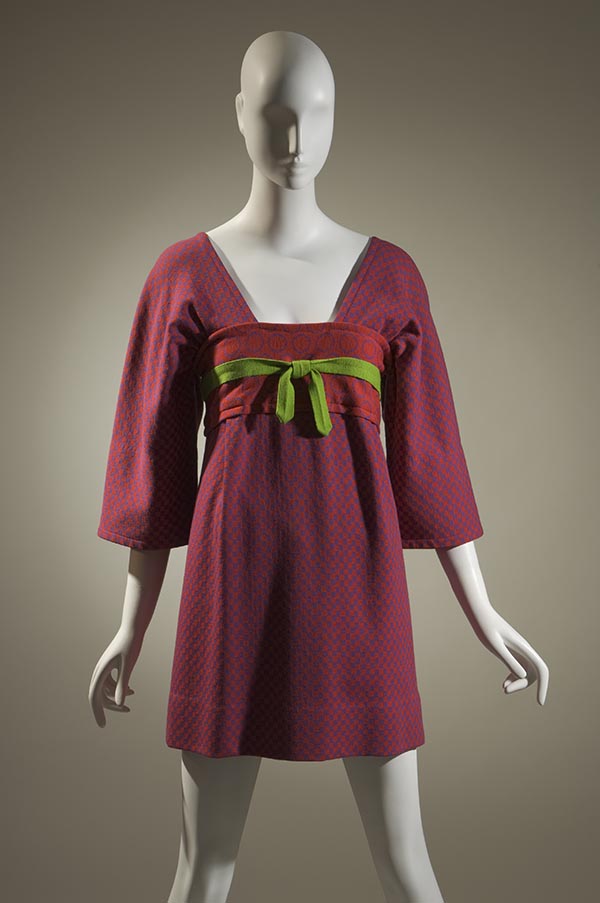 wool knit mini-dress with three quarter flared sleeves and a green ribbon