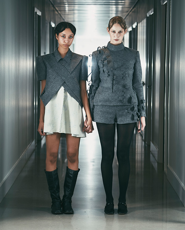 two models wearing grey jackets