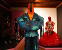 installation of moda hoy at museo franz mayer: blue suit with red ensemble in the back