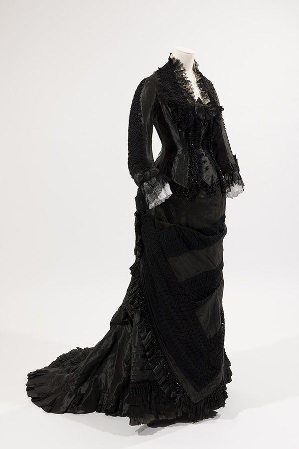 floor length, long sleeved black two piece dress with lace and ruffle detailing