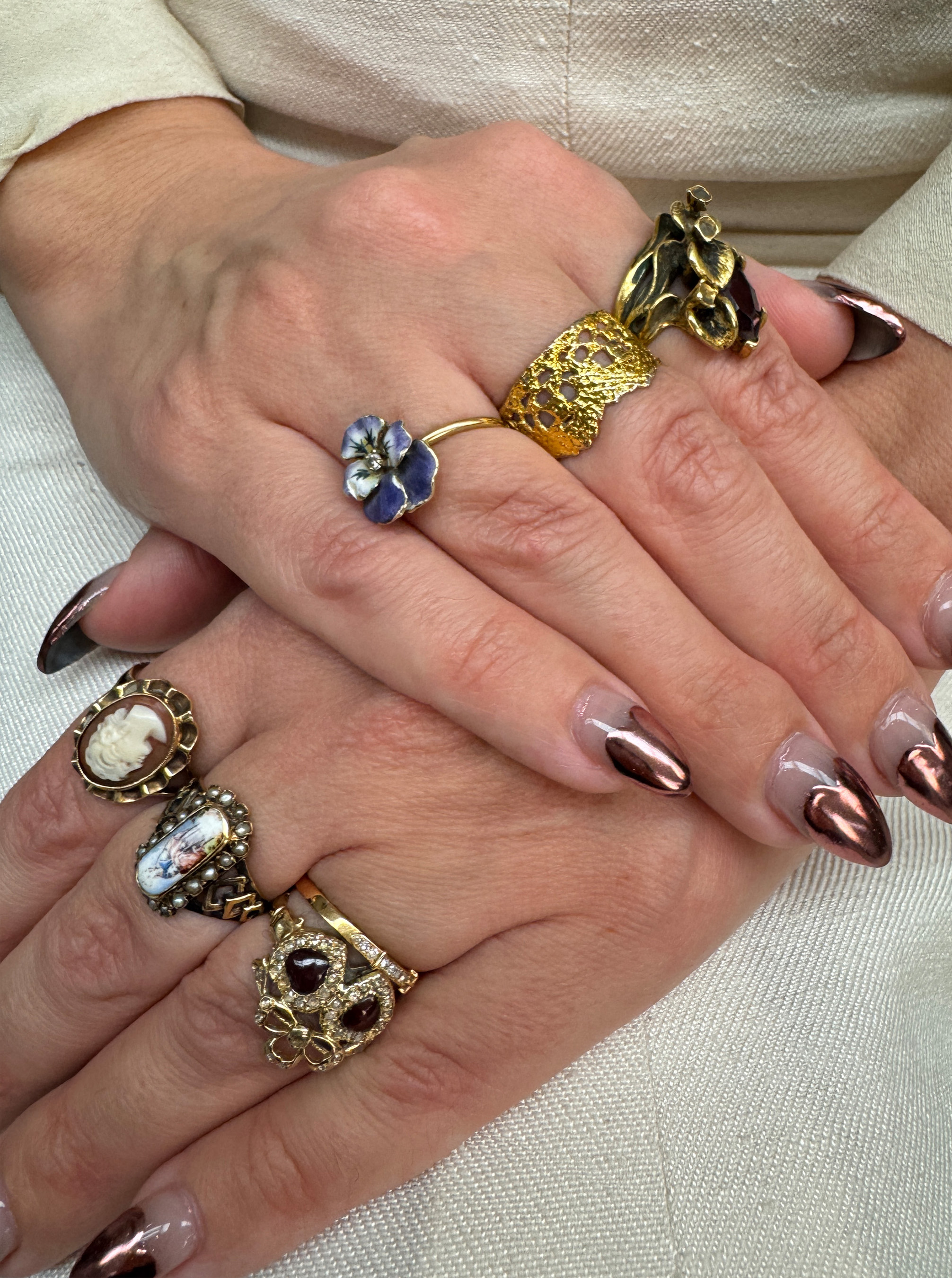 close up elena's hands with various gold, antique rings 