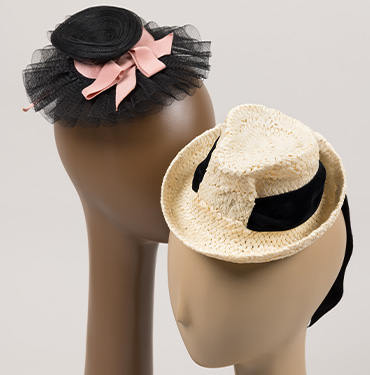 a black tulle fascinator hat with a pink bow, and a cream straw fedora hat with a black band