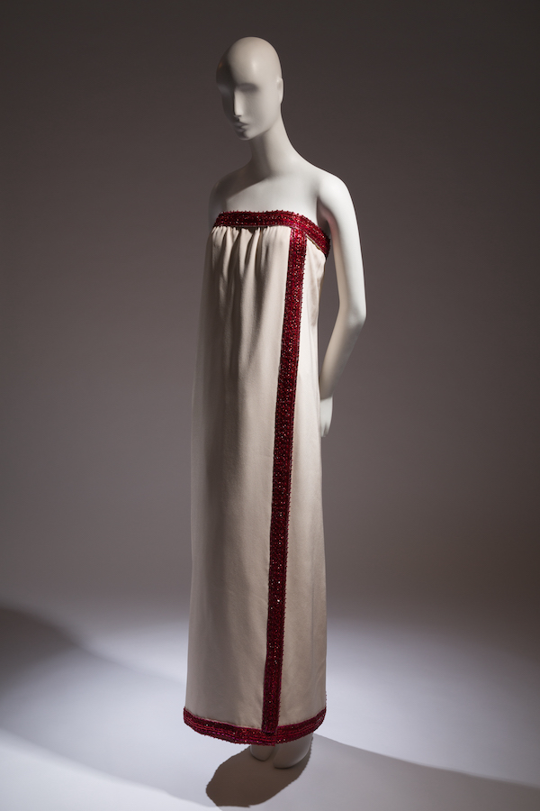 mannequin wearing strapless cream and red evening gown