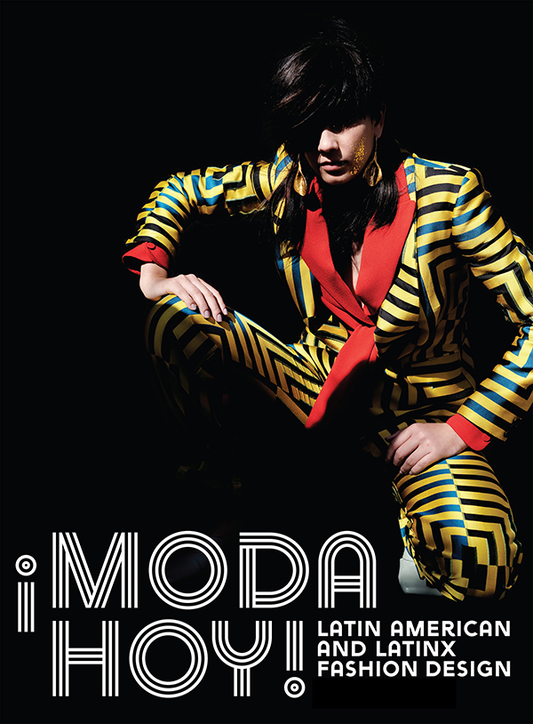 masculine model wearing yellow pantsuit with green geometric pattern and red trim with white text reading, 