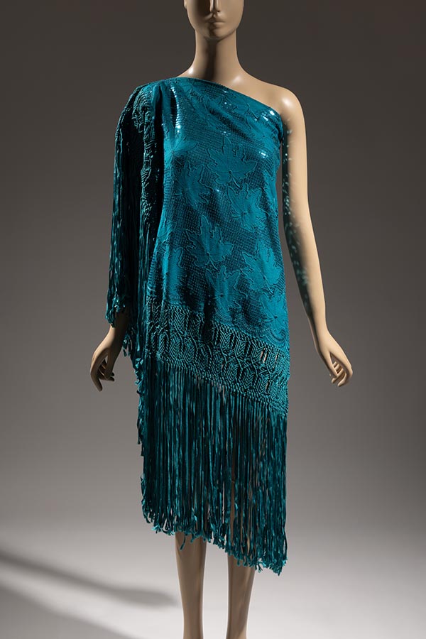 Blue asymmetrical one-shouldered dress made from upcycled flannel shawl embroidered with sequins with hand made macramé and fringe