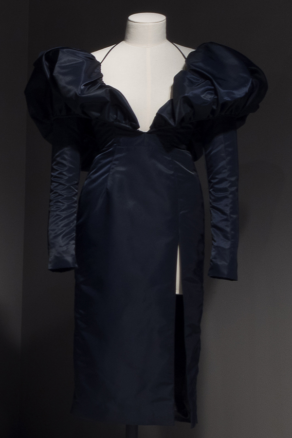 Dark blue knee-length dress with long fitted sleeves and oversize puffs at shoulder