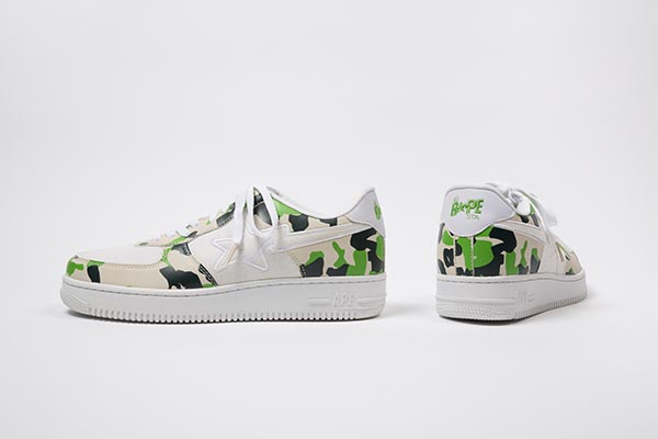 White sneakers with signature camouflage trim in dark green, neon green and tan, white canvas vamp and star stripe logo in white canvas on quarters, B*PE STA logo at counter and on white canvas tongue, CF white lacing over tongue, white rubber soles with molded APE logo at outer heel.