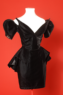 black low neckline dress with fang-like points projecting from the fabric